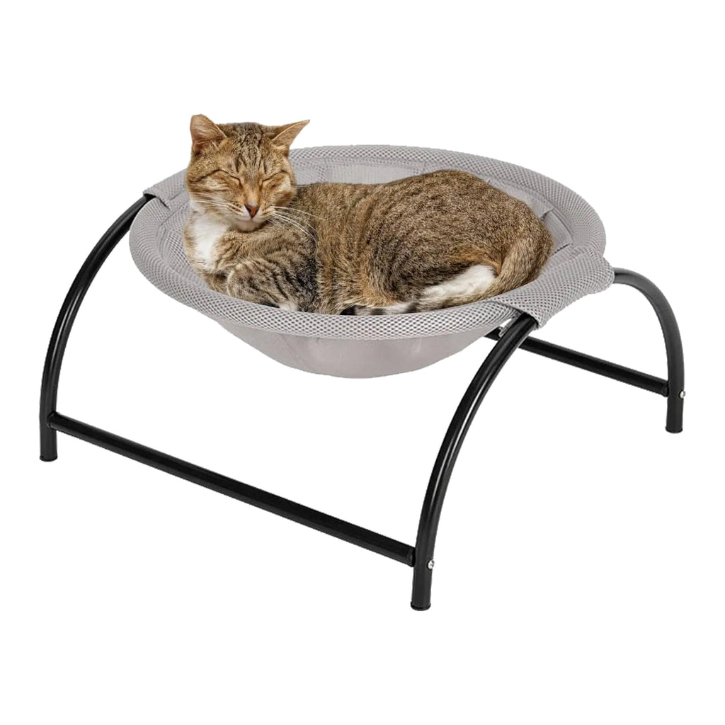Tabby cat curled up in a round grey mesh cradle on a low black arched metal stand