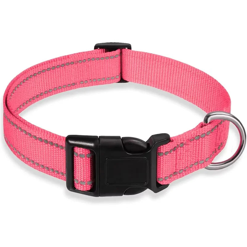Pink reflective nylon dog collar with black quick-release buckle and metal D-ring